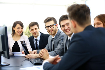 Group of business partners discussing ideas at meeting in office