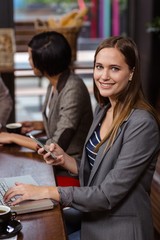 Smiling woman using smartphone