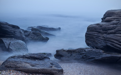 Long exposure of sea and rocks. Fog on the beach, Black Sea