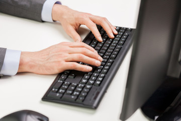 close up of businessman hands typing on keyboard