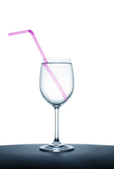 pink drinking straw in the wine glass full with water
