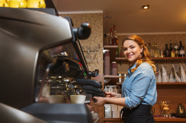 barista woman making coffee by machine at cafe