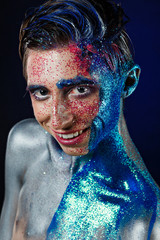 Crazy young androgyne man with face art. SPACEMAN. Freak person. Sperm on face. Tinsel creative...