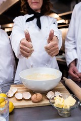 Head chef showing thumbs up while preparing dough