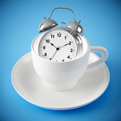 alarm clock in the white cup on blue background