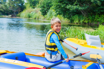 Happy boy kayaking on the river