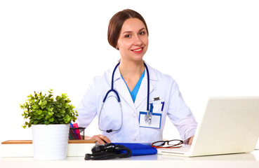Obraz premium Portrait of young female doctor sitting at desk in hospital