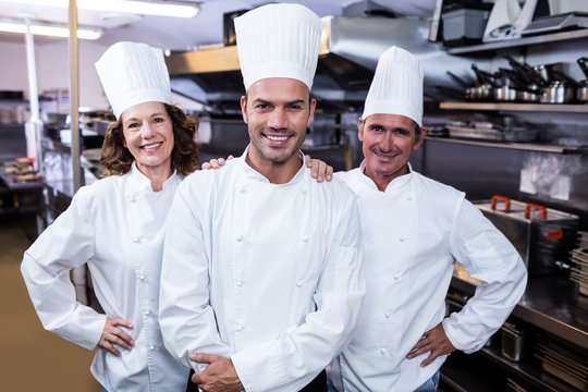 Group of happy chefs smiling at the camera 
