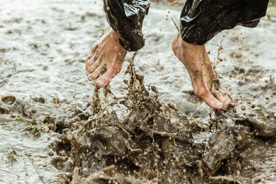 Feet splashing in muddy water