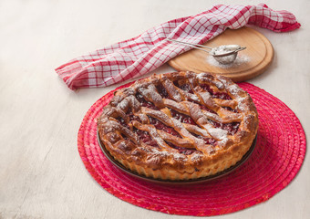 Open cherry pie on the red stand