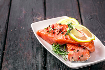marinated salmon with spices and lemon on a plate