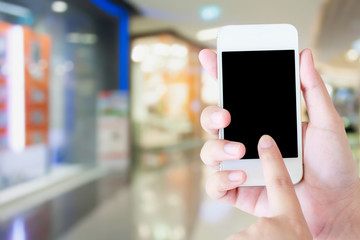 Fototapeta na wymiar hand hold mobile phone in shopping mall