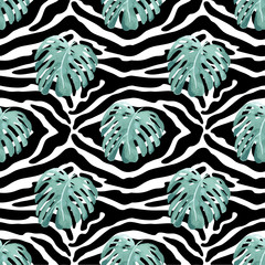 Seamless pattern with tropical leaves on the texture of the skin