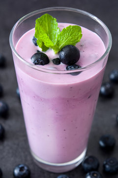 Fresh blueberry smoothie on black stone
