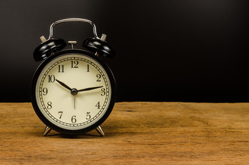 vintage alarm clock on wooden table