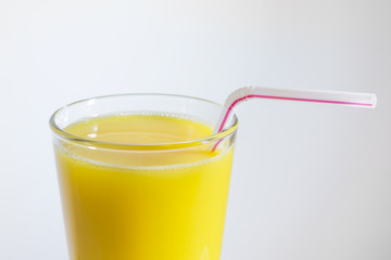 glass of orange juice with a straw