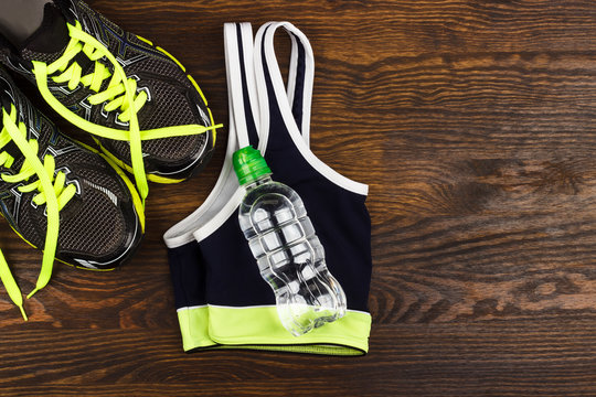 Sneakers, bottle and sports bra