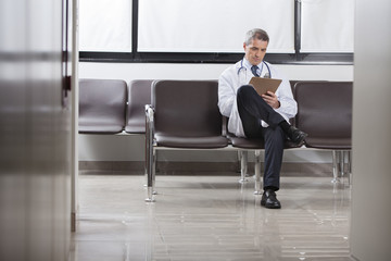 Doctor writing up patient charts