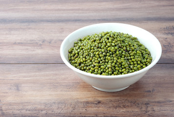 Mung beans in a bowl with wooden table