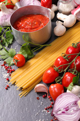 raw spaghetti and tomato sauce