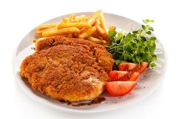 Fried pork chop, French fries and vegetables 
