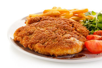 Fried pork chop, French fries and vegetables 