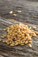 Dried pine nut seeds set on old wooden surface