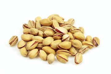 Dried pistachio seeds, on white background.