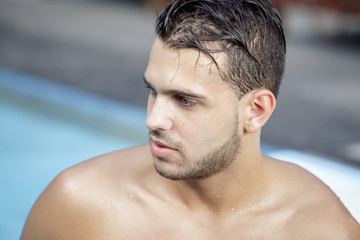 Young man posing in the swimming pool