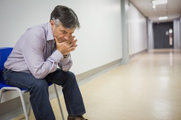 Thoughtful professor sitting on chair
