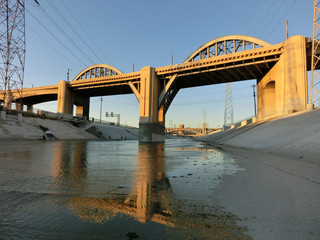 Fototapeta na wymiar Beautiful bridge over LA river canal at dusk with reflection - landscape color photo