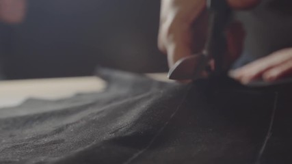 Dressmaker cutting fabric - Powered by Adobe