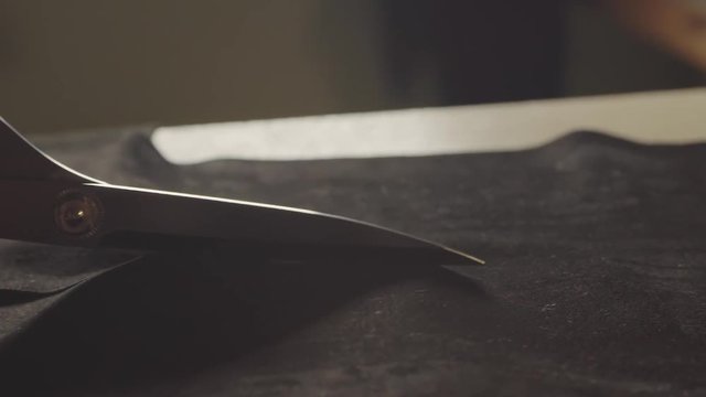 Dressmaker cutting fabric