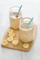Banana smoothies on white wood

