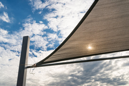 Sunshade in sails shape and blue sky background