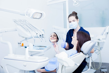 Obraz na płótnie Canvas At the dentist. Female dentist in action. Sharpen on dentist