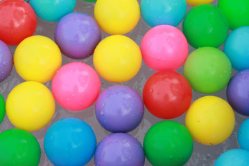 Fototapeta na wymiar Colorful plastic balls floating on the water