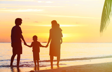 happy family with two kids at sunset