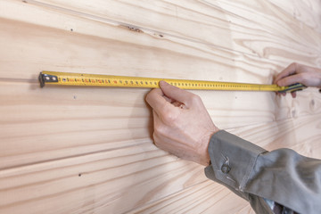 construction Worker using a measuring tape