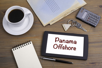 Panama Offshore. Text on tablet device on a wooden table