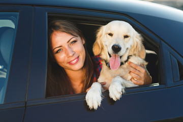 Woman and dog in car on summer travel