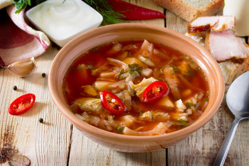 Vegetable soup with beetroot (borscht) on a wooden table