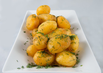Dish with boiled and fried potatoes with dill.