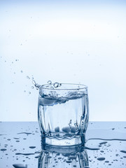 a glass of water ice drops splashes freshness thirst