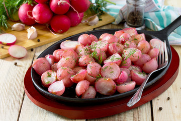 Rice fried in oil on a cast-iron frying pan