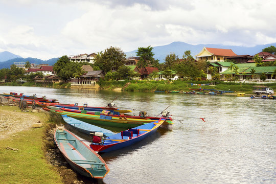 Colourful boats by the Song river in Vang Vieng, Laos.