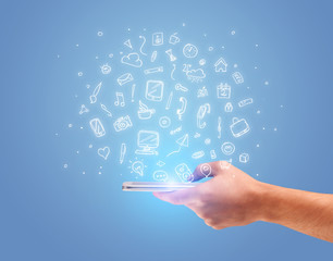 Hand with phone and drawn office icons