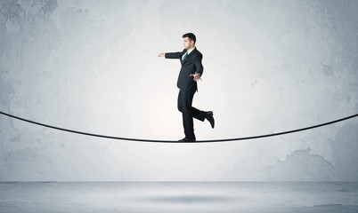 Sales guy balancing on tight rope
