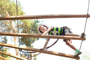 Six years boy on rope-way in the forest