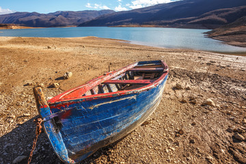 Fototapeta premium Lake with boat at beach, and blue sky with clouds